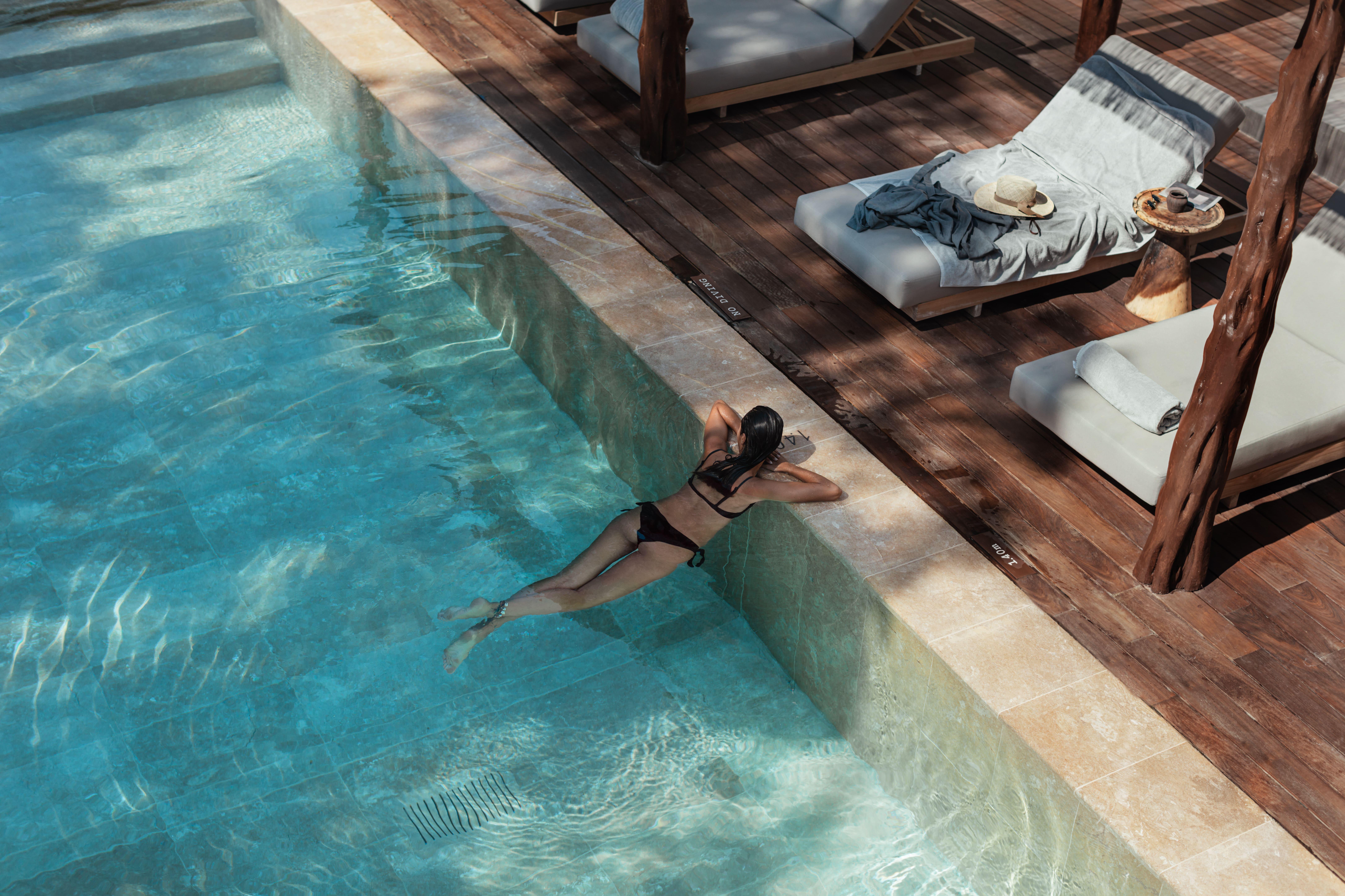 Oku Ibiza (Adults Only) Hotel San Antonio Kültér fotó A woman swimming in a pool